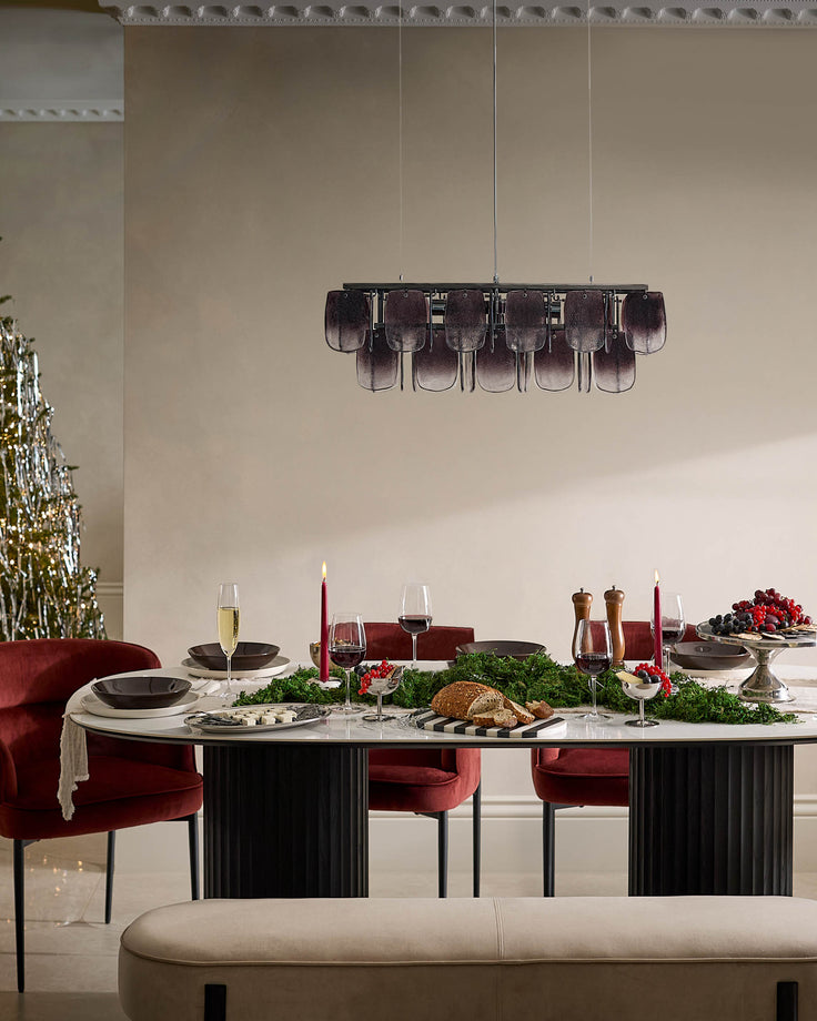 Felix dining chair in toffee red velvet with black metal legs, shown at elegant dining table setting.