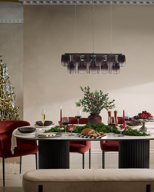 Champagne velvet bench with blackwood frame, shown in elegant dining room setting.
