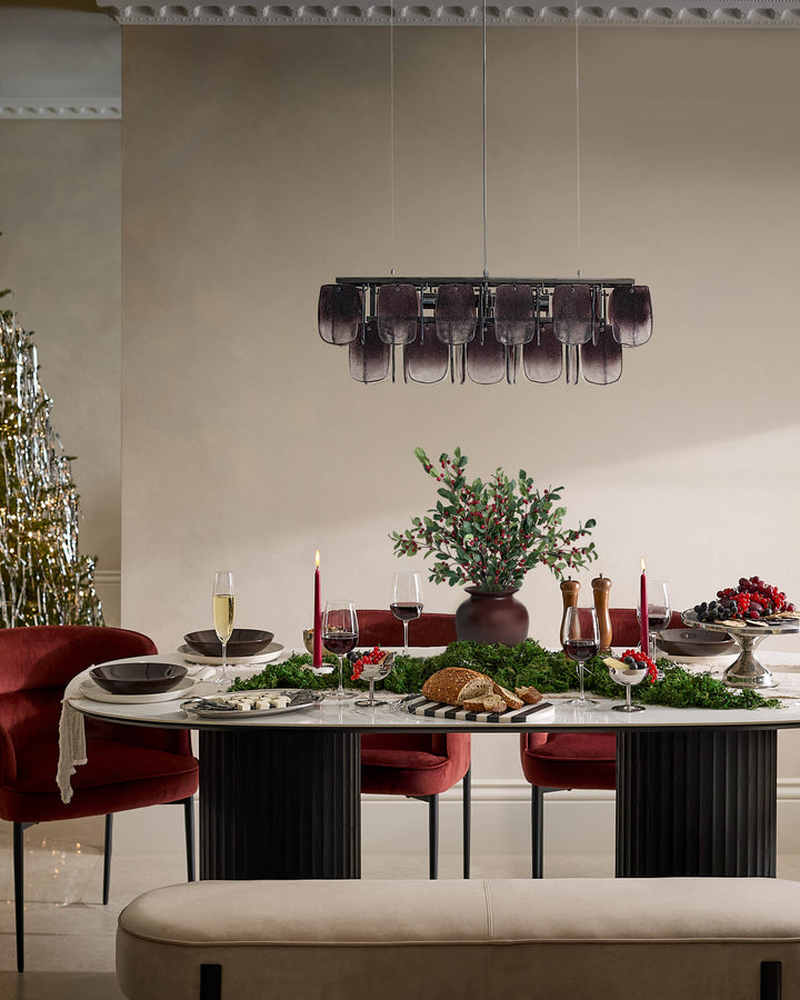 Champagne velvet bench with blackwood frame, shown in elegant dining room setting.