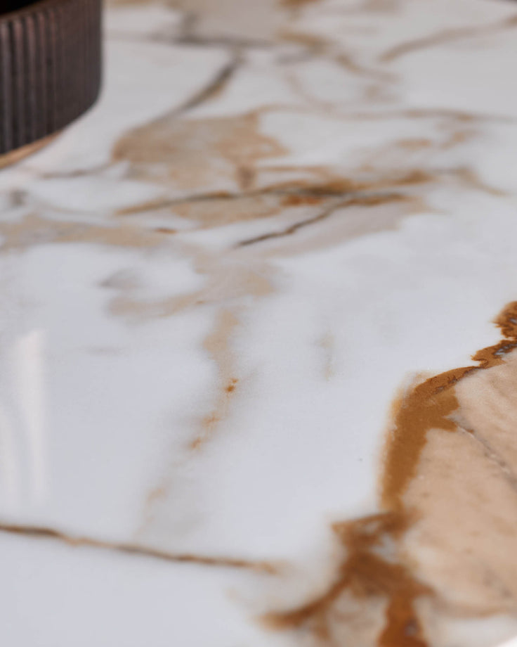 A modern marble table top with distinctive brown and white veining, showcasing luxurious design for your living space.