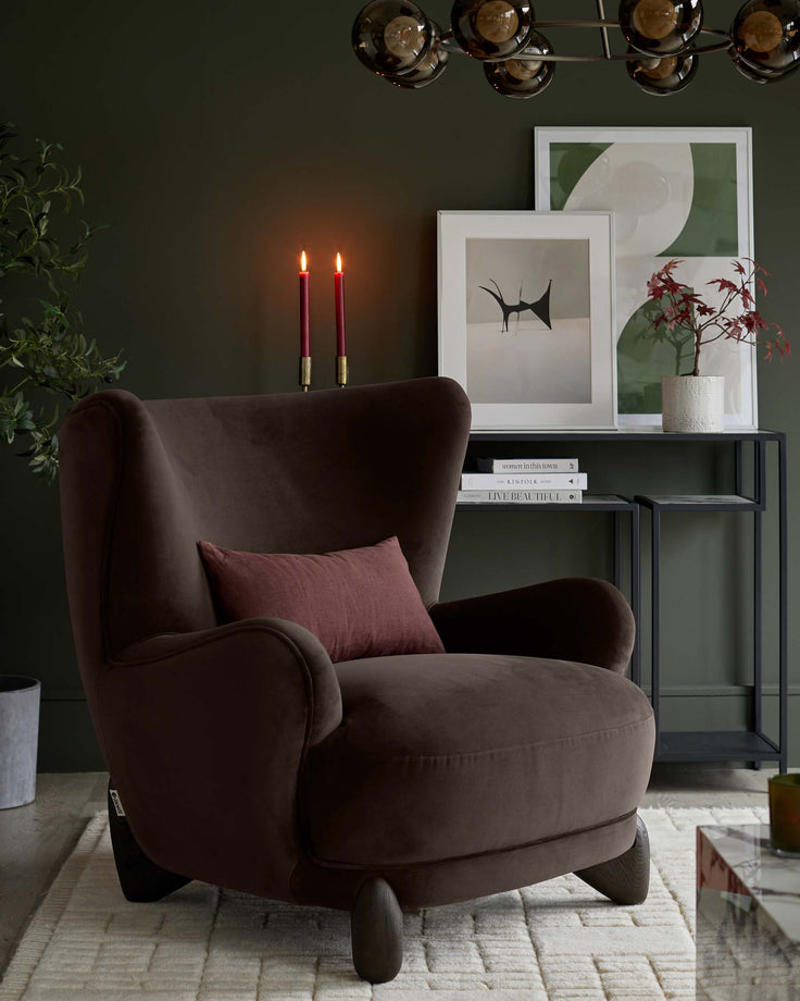 Stylish living room featuring a brown armchair with wingback design, complemented by a sleek console table and artful decor.