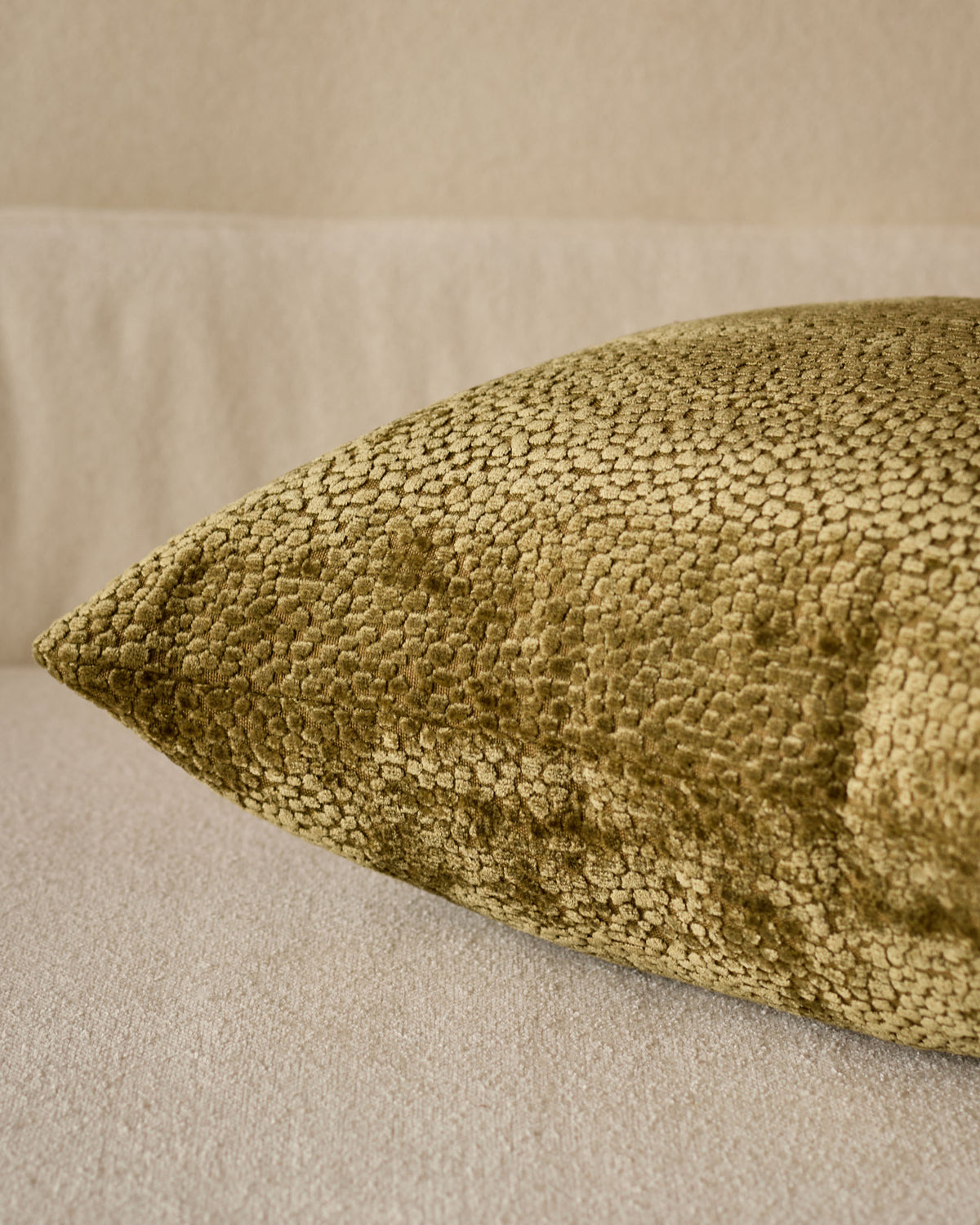 Harlene cushion in medium olive green, close-up detail showing textured woven fabric surface.