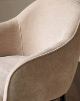 Harley bar stool in champagne fabric, close-up side view showing curved armrest and seat upholstery detail.