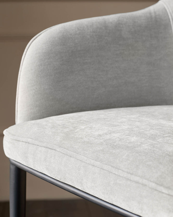 Harley bar stool in natural grey fabric, showing curved backrest and seat detail with dark metal base.