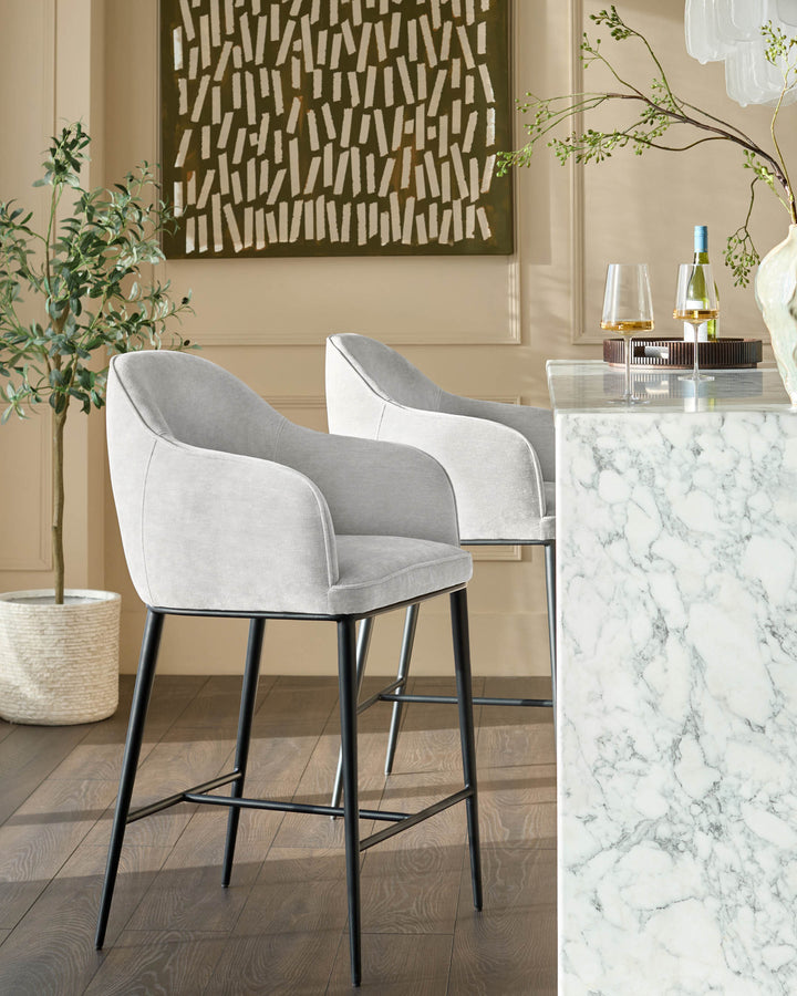 Harley bar stool in natural grey fabric with black metal legs, shown at marble counter in modern dining setting.