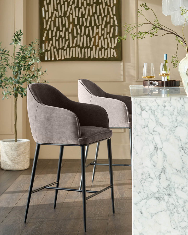 Mocha fabric bar stool with curved backrest and black metal legs, shown in styled room setting.