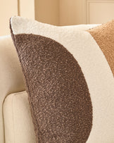 Harmony Cushion Medium in Natural, showing textured brown and cream striped boucle fabric on a cream upholstered sofa.