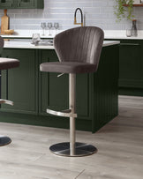 Harper mocha velvet gas lift bar stool with brushed metal base, shown at kitchen island with green cabinetry.