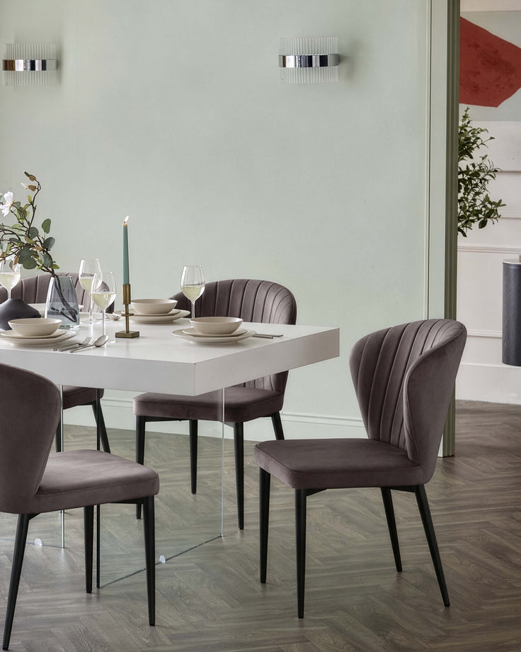 Harper dining chair in mocha velvet with black metal legs, shown at a dining table setting.
