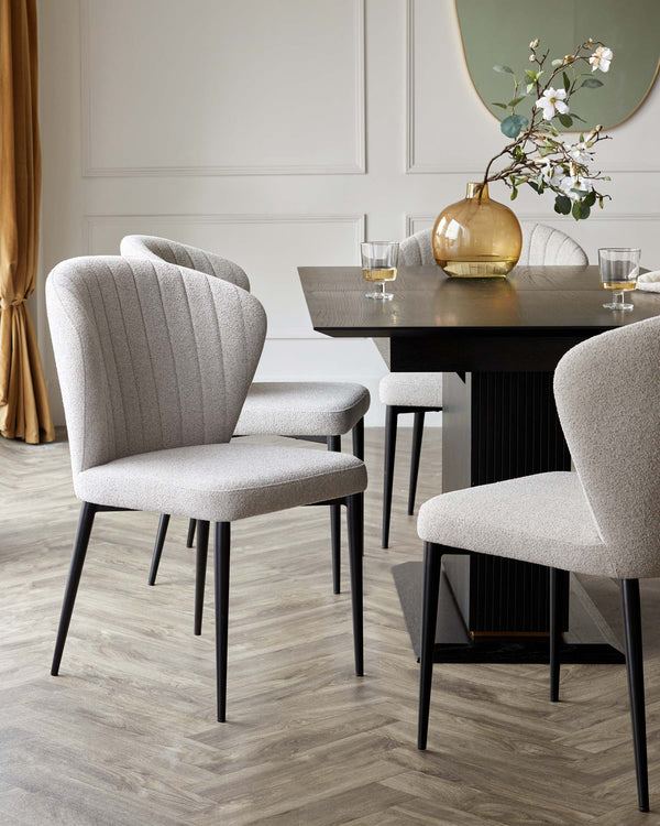 A dining set with elegant light grey chairs and a sleek dark wood table, creating a stylish dining space.