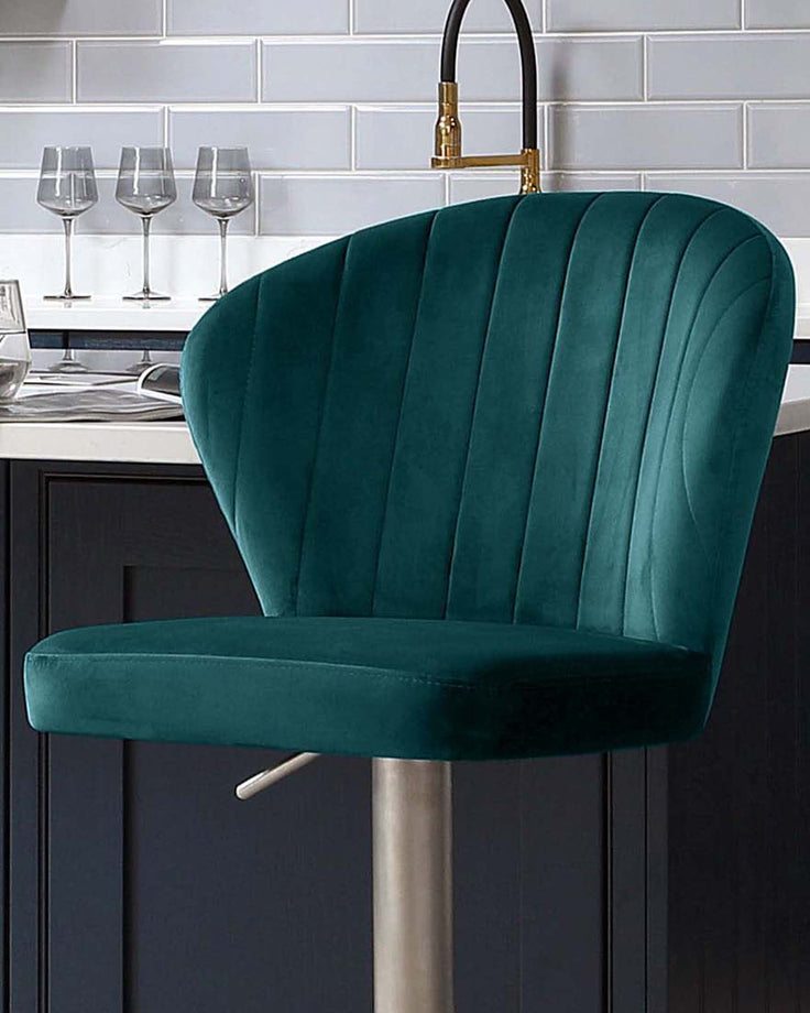 Harper velvet gas lift bar stool in dark teal with vertical channel stitching and chrome base, shown at kitchen island.