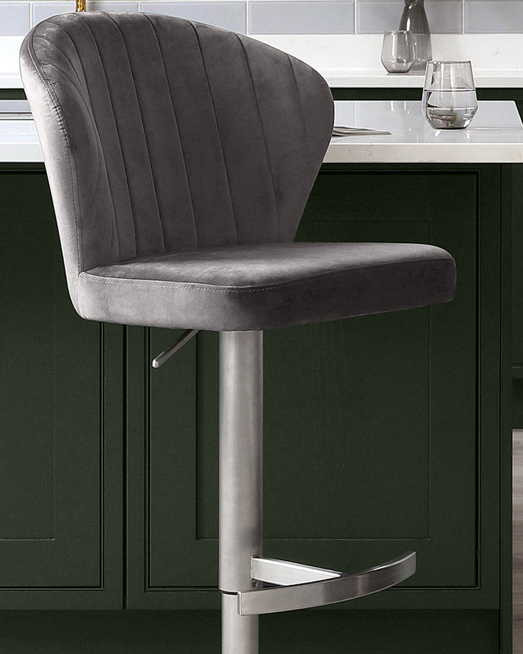 Harper dark grey velvet gas lift bar stool with chrome base and footrest, shown at kitchen counter.