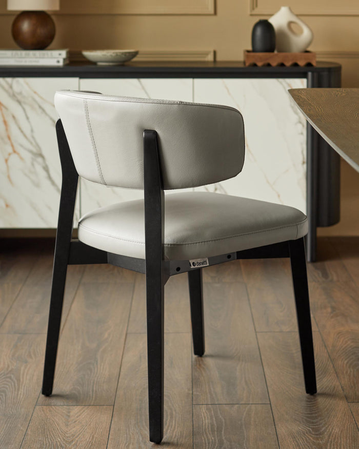 Stylish grey leather chair with black frame. A modern design for any dining space.