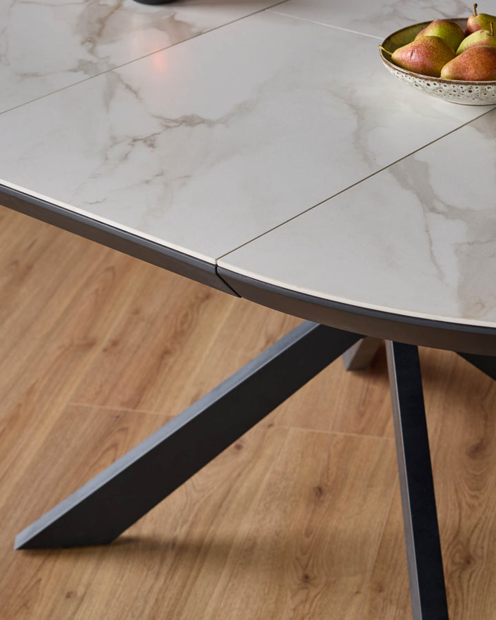 A stylish table with a marble-effect top and dark metal legs, ideal for a modern dining room.