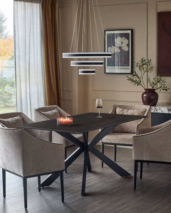 Hayden 6-seater dining table in dark grey ceramic with black metal X-frame base, shown in modern dining room setting.