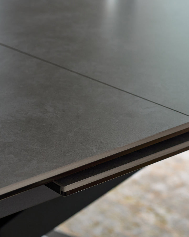 Hayden extending dining table in light grey ceramic, close-up of brushed metal handle detail.