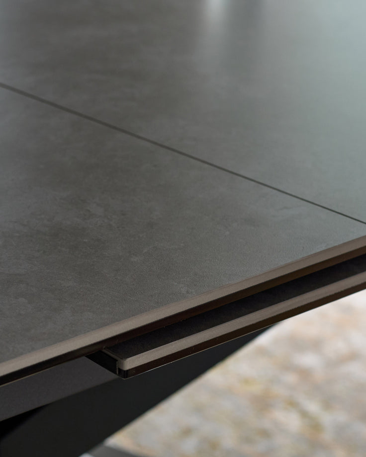 Hayden extending dining table in light grey ceramic, close-up of brushed metal handle detail.