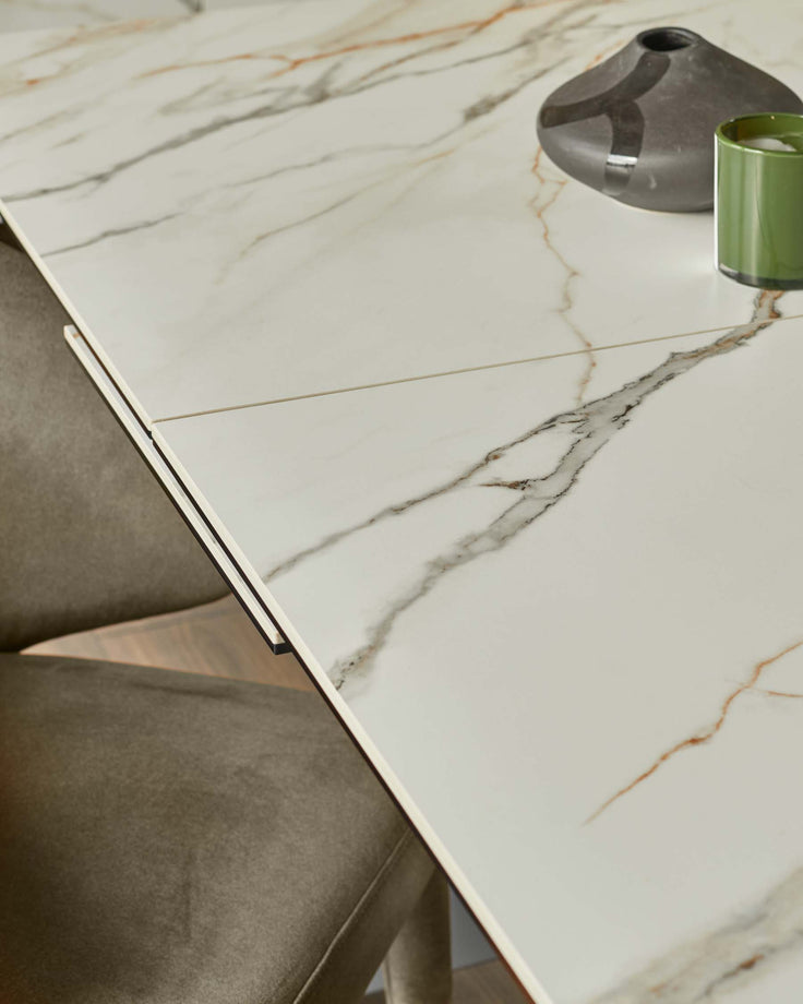 A modern marble-effect table is on display, alongside sleek upholstered chairs, in this inviting studio shot.