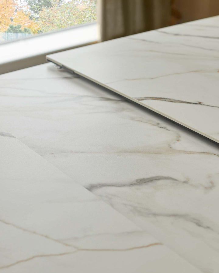 Marble effect dining table extending section in situ. Neutral colour palette.