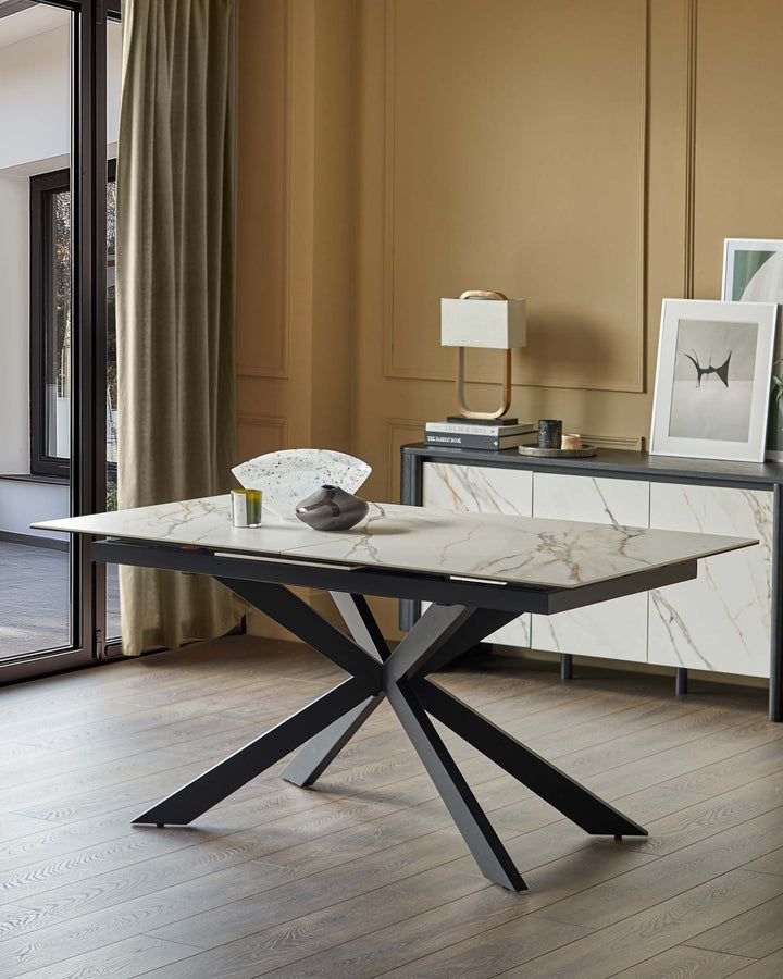An extendable dining table with a marble-effect top and a striking black metal base.