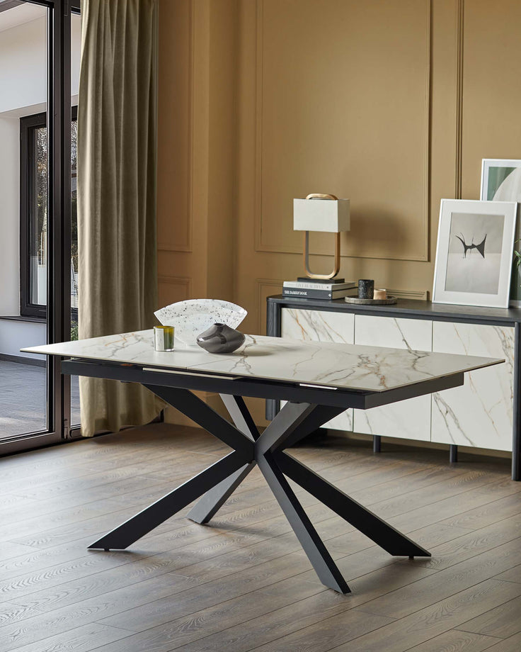 An extendable dining table with a marble-effect top and a striking black metal base.
