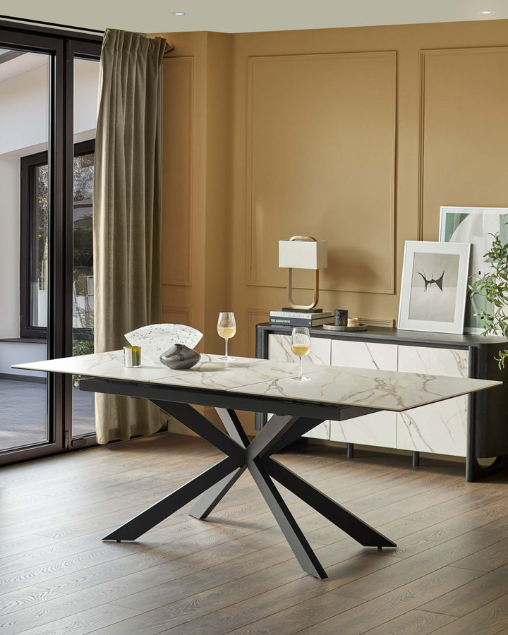 A dining room showcases a modern marble table with a sleek, striking black base and matching sideboard for a stylish look.