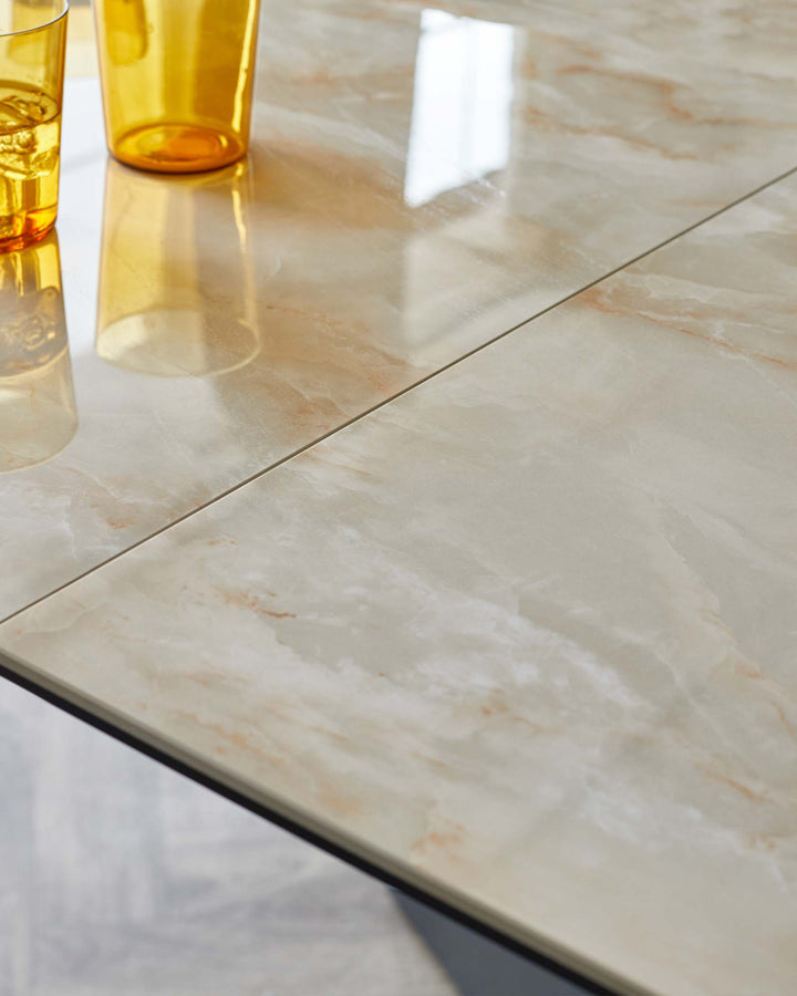 Elegant, marble-patterned tabletop with a high-gloss finish, featuring cream and light brown veining details and a slim black edge highlight.