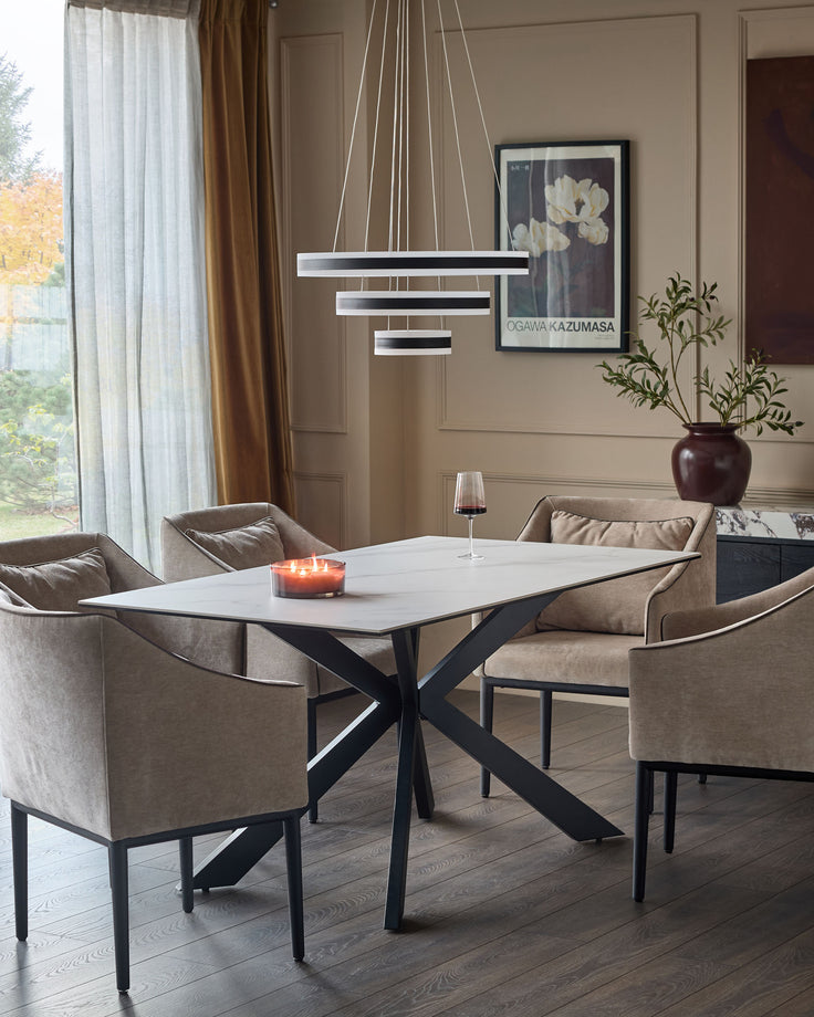 Hayden 6-seater dining table with white ceramic top and black X-frame base in modern dining room setting.