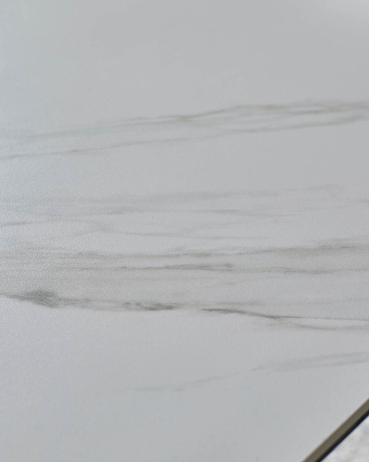 Close-up of white ceramic tabletop with Grey wood grain texture and subtle veining detail.