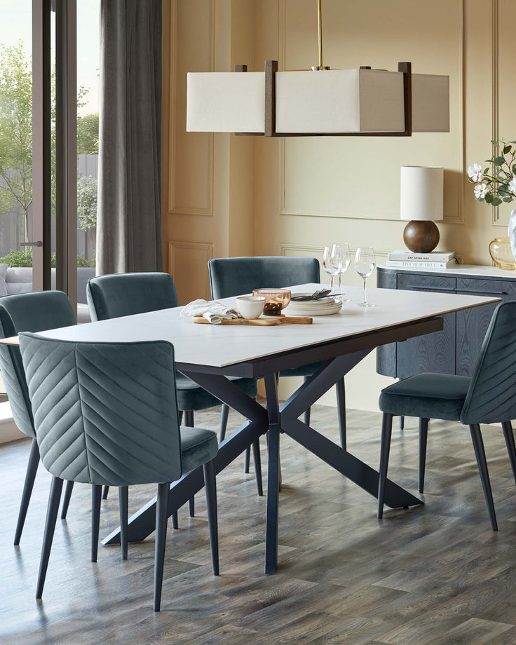 A dining set with a white table, six plush chairs, and a modern light fixture adds style to any dining room.