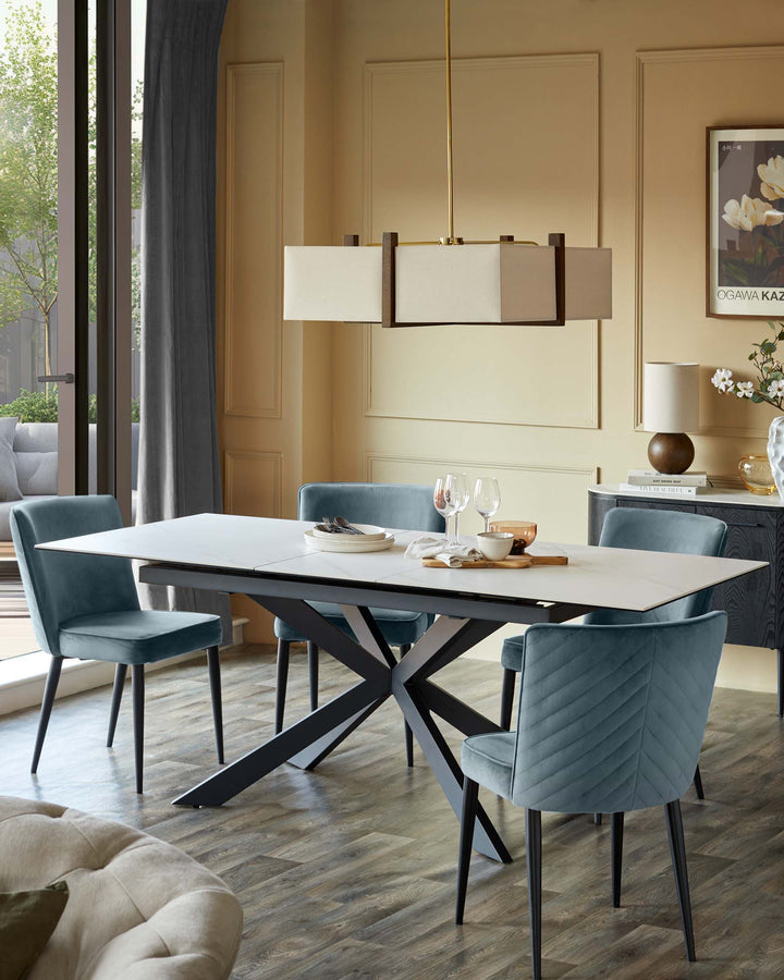 Dining room with marble-look extendable table and blue velvet chairs. Statement lighting, stylish and modern.