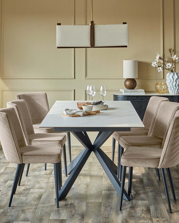 A dining table with 4 chairs, lamp and cabinet in the background, all in neutral colours.