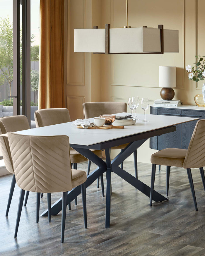 A dining set with a white table, six beige chairs, and a buffet in a neutral-toned room with a modern chandelier.