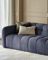 Hayes 3-seater sofa in dark blue weave fabric with channel quilting, styled with neutral pillows in a bright room.