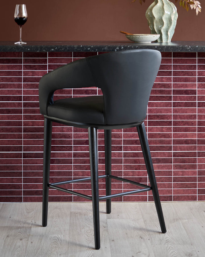 Stylish black leather bar stool with sleek, modern design. Ideal for any contemporary kitchen or bar area.