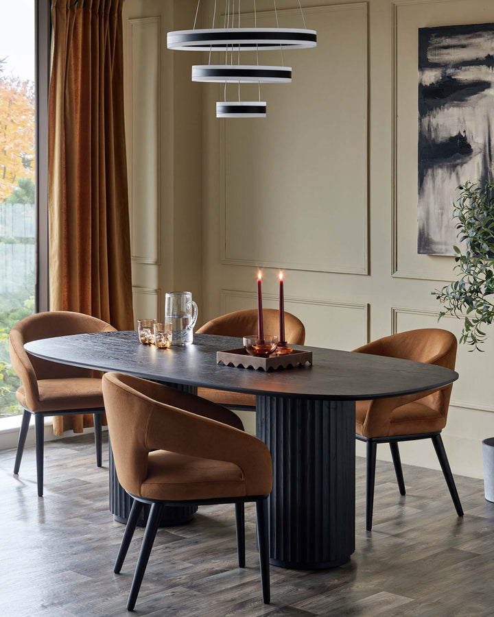 A dining room featuring a dark wood table, stylish brown upholstered chairs, and a modern ring chandelier.