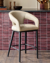 Stylish bar stool with cream seat and black metal legs. A chic addition to any kitchen or bar area.