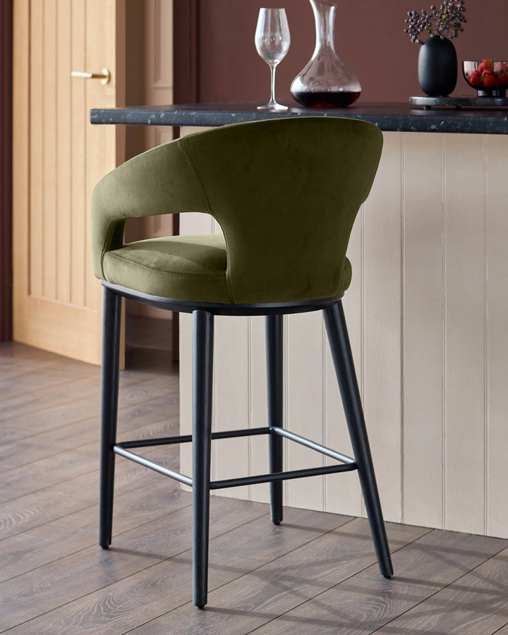 A stylish green velvet bar stool with a black frame adds a touch of elegance to any kitchen or bar area.