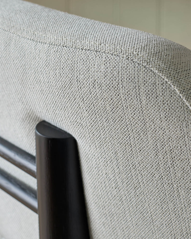 Henley bar stool in ivory fabric, close-up detail showing woven texture and black metal frame.