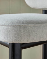 Henley bar stool with ivory fabric seat and blackwood frame, close-up detail view.