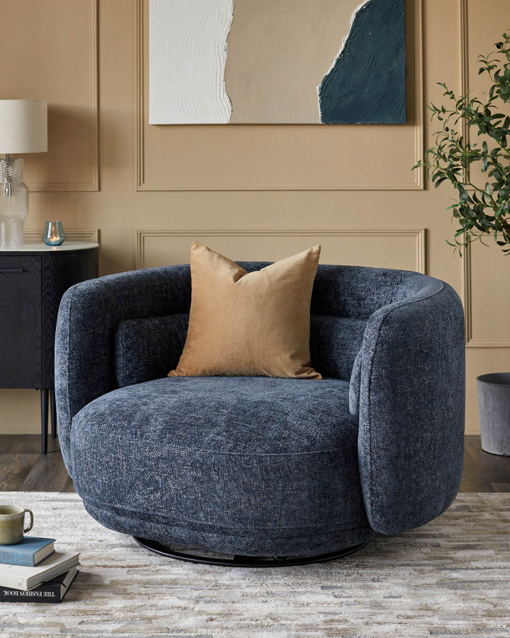 Stylish blue swivel chair with a tan cushion in a neutral-toned living room setting.