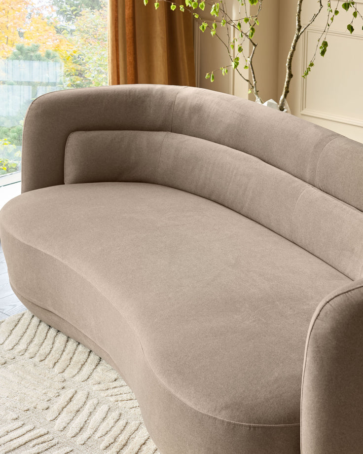 Henry 3-seater sofa in mocha fabric, curved design, angled side view showing plush seating and rounded backrest.