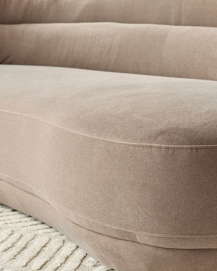 Henry 3-seater sofa in mocha fabric, curved design with stitched seams detail, close-up of seat cushion and armrest.