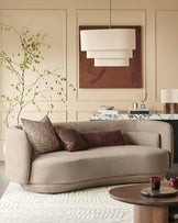 Henry 3-seater sofa in mocha fabric with curved arms and rounded base, styled in a modern living room setting.