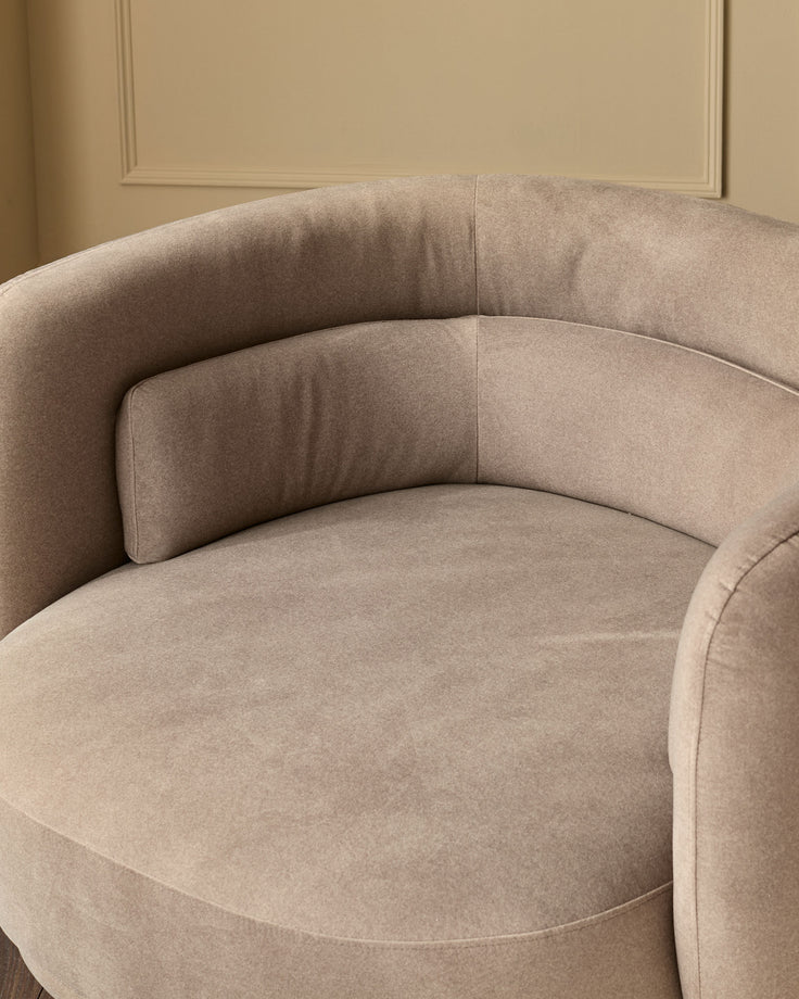 Henry Swivel Love Seat in mocha fabric, showing curved armrests and plush seating from a side angle.