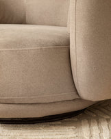 Henry swivel love seat in mocha fabric, close-up of curved armrest and base detail on neutral rug.