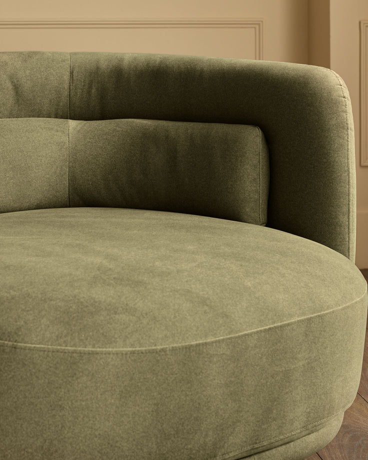 Henry swivel love seat in olive green velvet, curved design with rounded armrests, detailed side view.