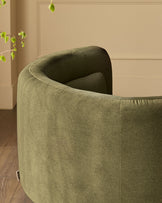 Henry Swivel Love Seat in olive green velvet, shown from rear angle highlighting curved back and upholstered design.