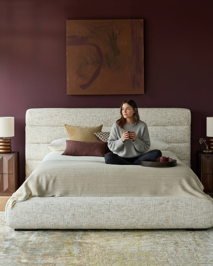 Hepworth King-Size Ottoman Bed in natural fabric, shown in a styled bedroom with coordinating pillows and bedding.