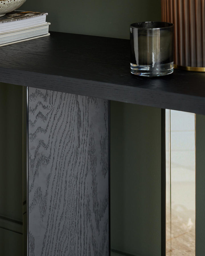Dark wood shelving unit with dark glass and reflective metal accents. Stylish and modern storage solution.